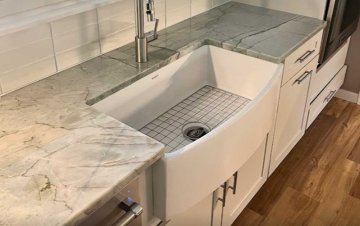 The elegant farmhouse sink, with its deep basin and smooth c...