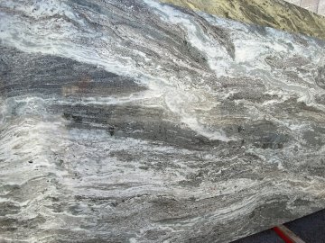 "A stunning slab of marble showcases a mesmerizing dance of ...