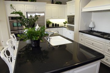 "Polished black granite countertops exude sophistication, pr...